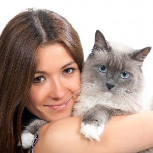 Young woman hold Ragdoll cat blue eye and smile isolated on a white background