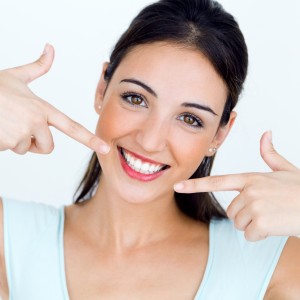 Portrait of beautiful young woman with perfect smile. Isolated on white.